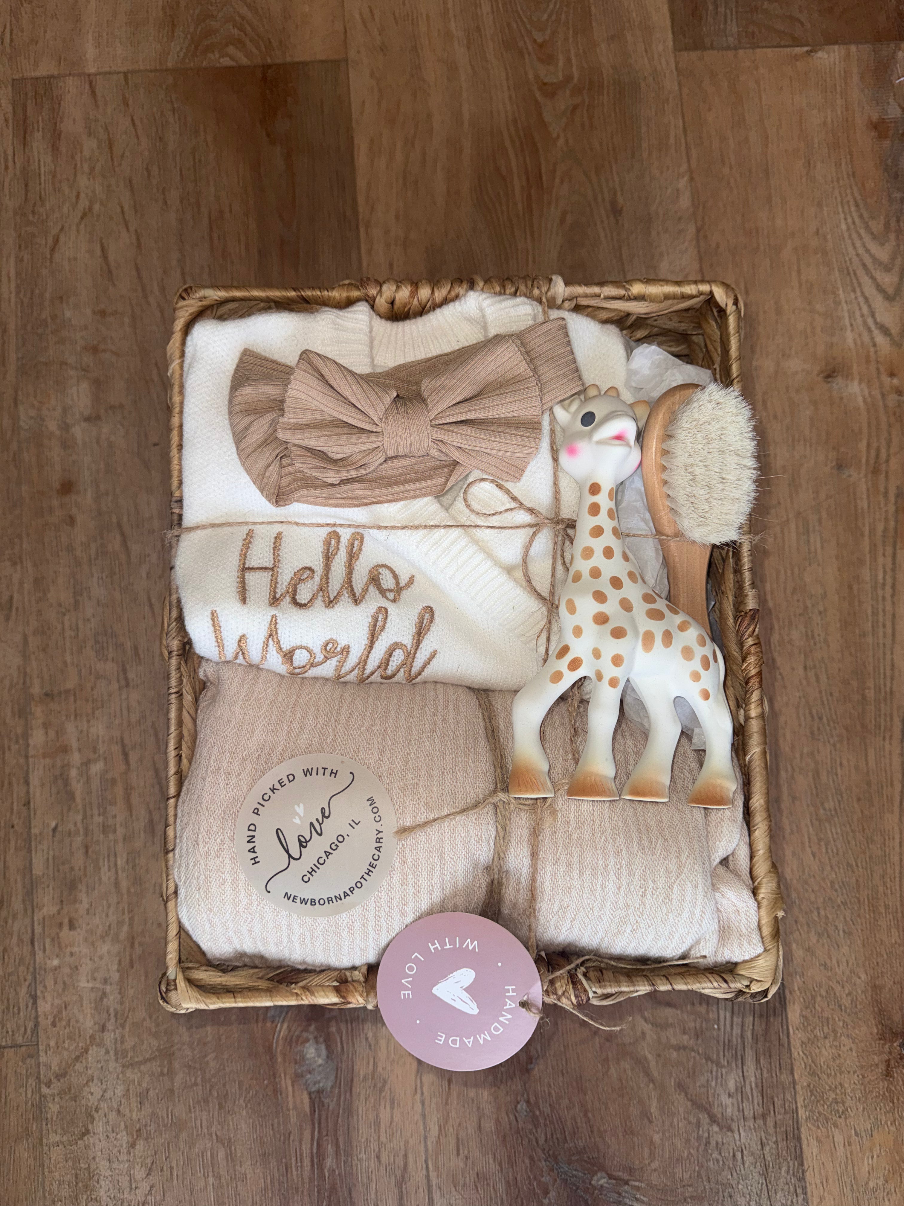 Baby girl, tan and white gift basket featuring Sophie the giraffe (6 pieces)